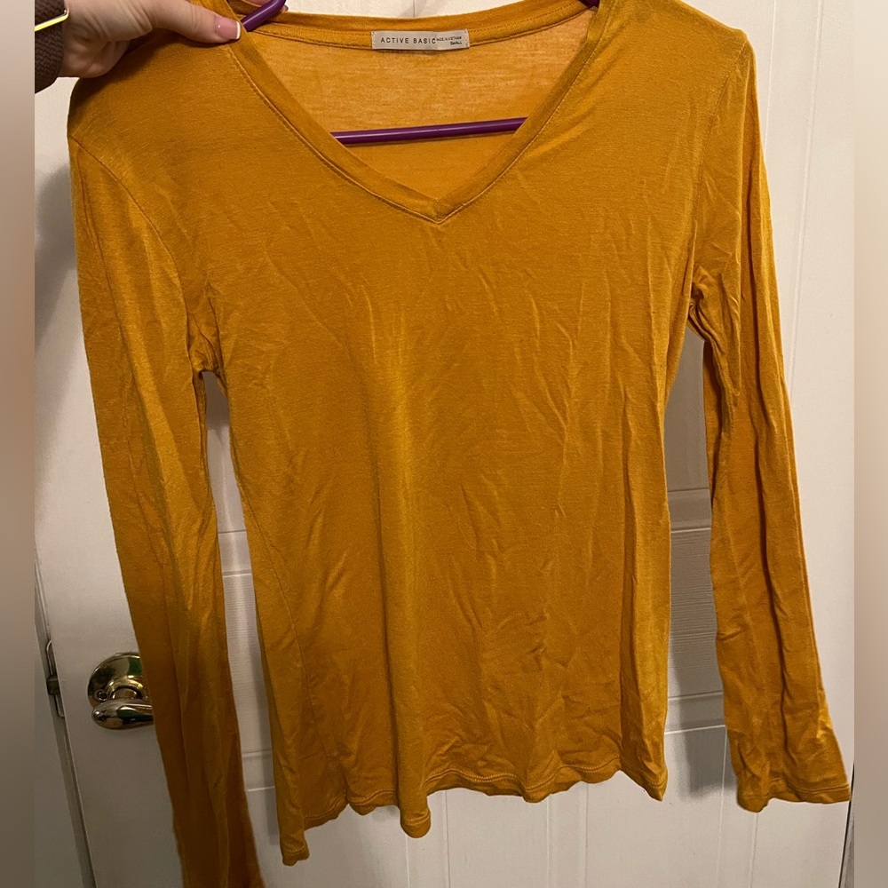 Simple, cute, fitted, orange color shirt.